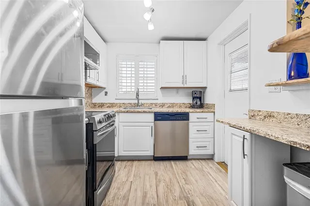 a kitchen with a sink stove and cabinets