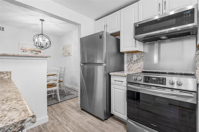 a kitchen with stainless steel appliances granite countertop a stove and a refrigerator