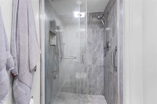 a bathroom with a glass shower door
