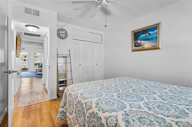 a bedroom with a large bed and a chandelier