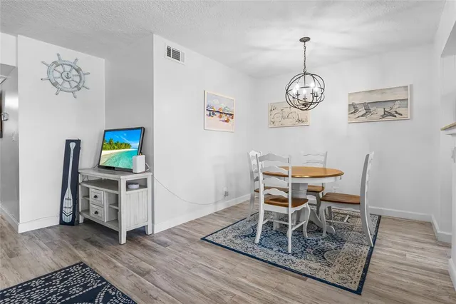 a dining room with furniture and wooden floor