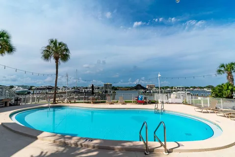 a swimming pool with outdoor seating and yard