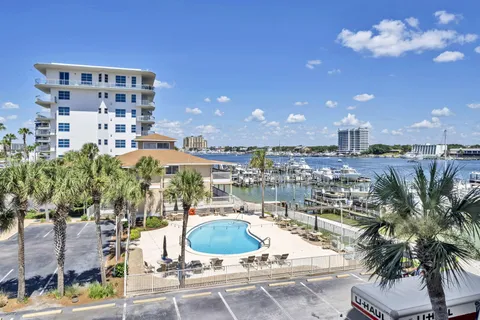 a view of a kitchen with granite countertop a sink and a stove