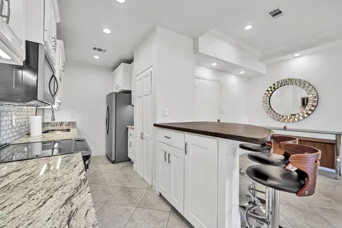 a kitchen with stainless steel appliances granite countertop a sink and cabinets