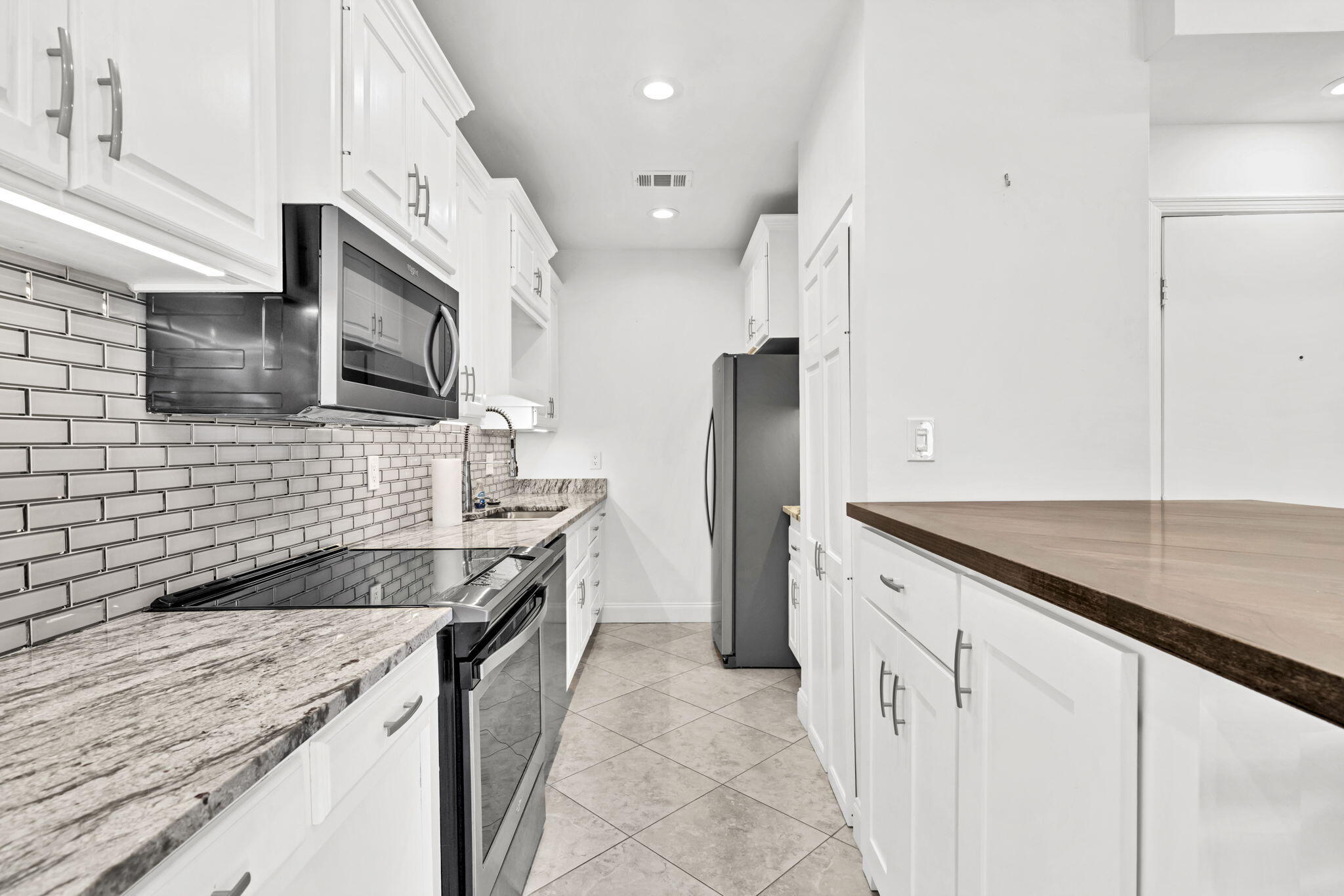 195 Durango Road, Unit 3A Destin, FL 32541 - Photo 3 of 41 a kitchen with stainless steel appliances granite countertop a sink and a stove