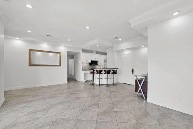 a view of a hallway with seating area