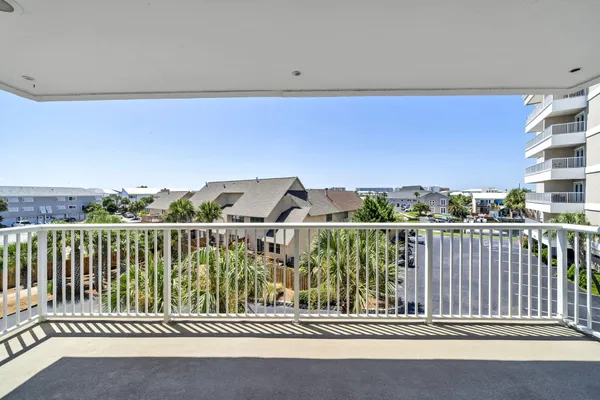 a view of a balcony with an outdoor seating