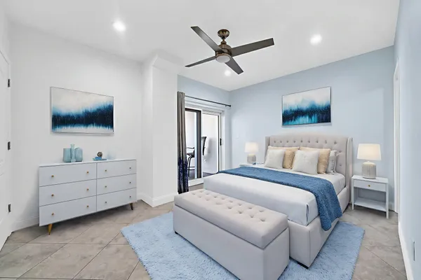 a spacious bedroom with a bed and a flat screen tv