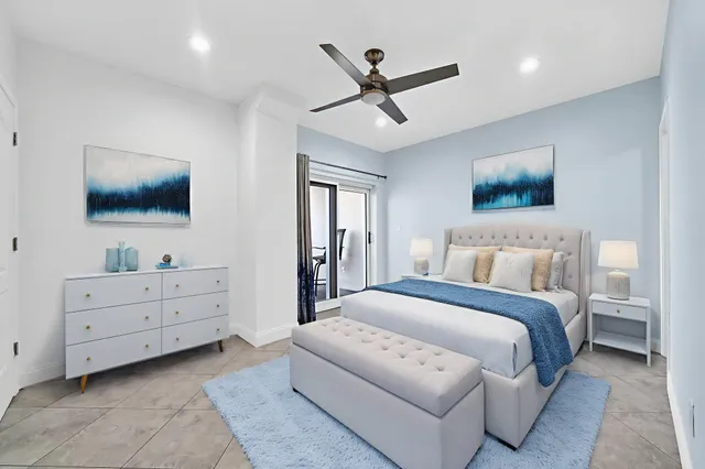 a spacious bedroom with a bed and a flat screen tv