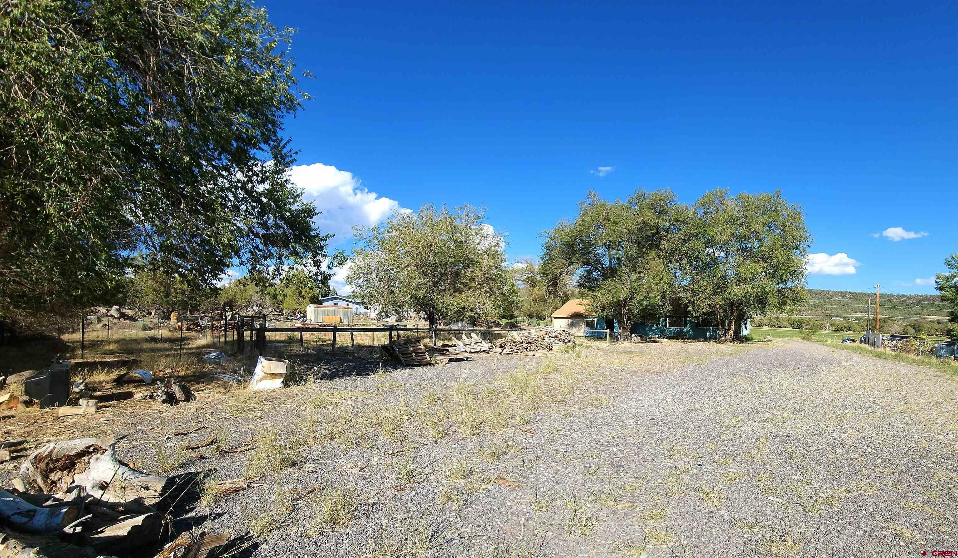 17867 Surface Creek Road Cedaredge, CO 81413 - Photo 25 of 31 a view of a yard with a tree