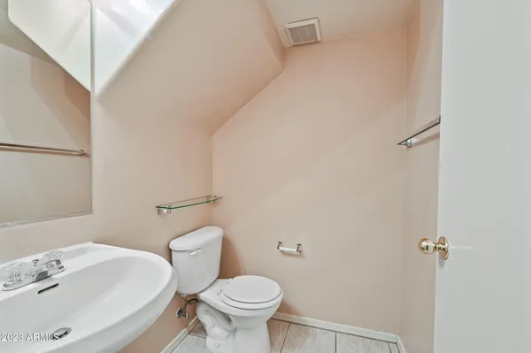 a white toilet sitting next to a bathroom sink