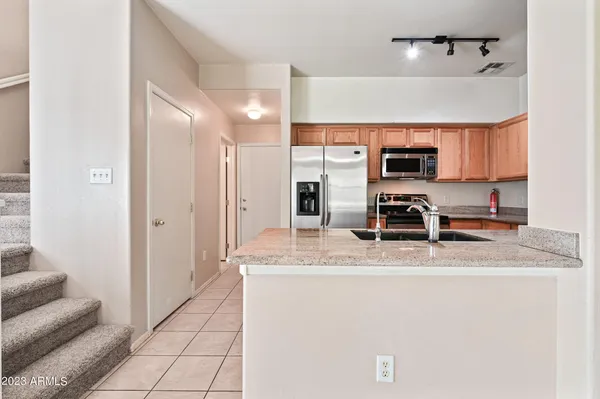 a kitchen with kitchen island a counter top space appliances and cabinets