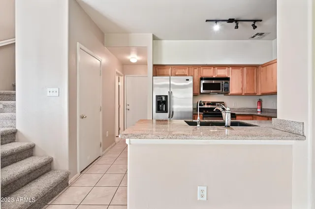 a kitchen with kitchen island a counter top space appliances and cabinets