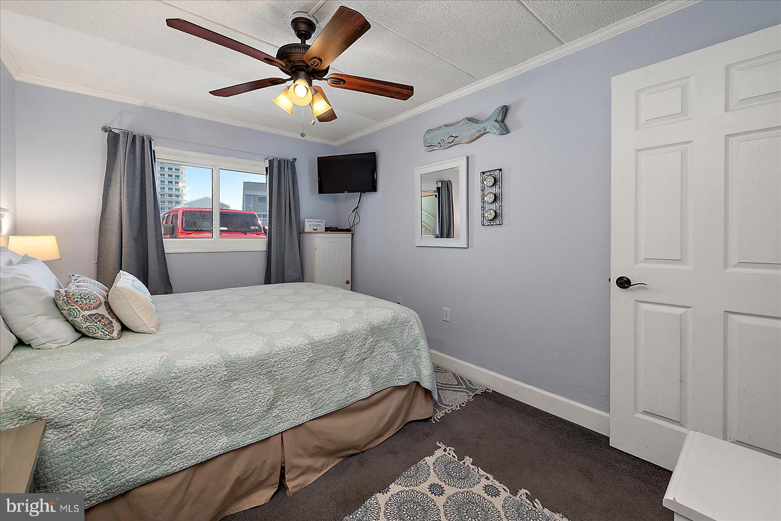 4 46th Street, Unit 101 Ocean City, MD 21842 - Photo 16 of 27 a bedroom with a bed and window