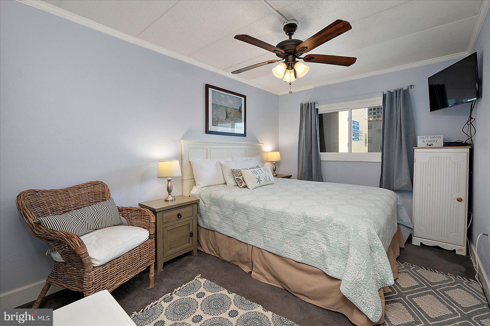 4 46th Street, Unit 101 Ocean City, MD 21842 - Photo 17 of 27 a bedroom with a bed furniture and a window