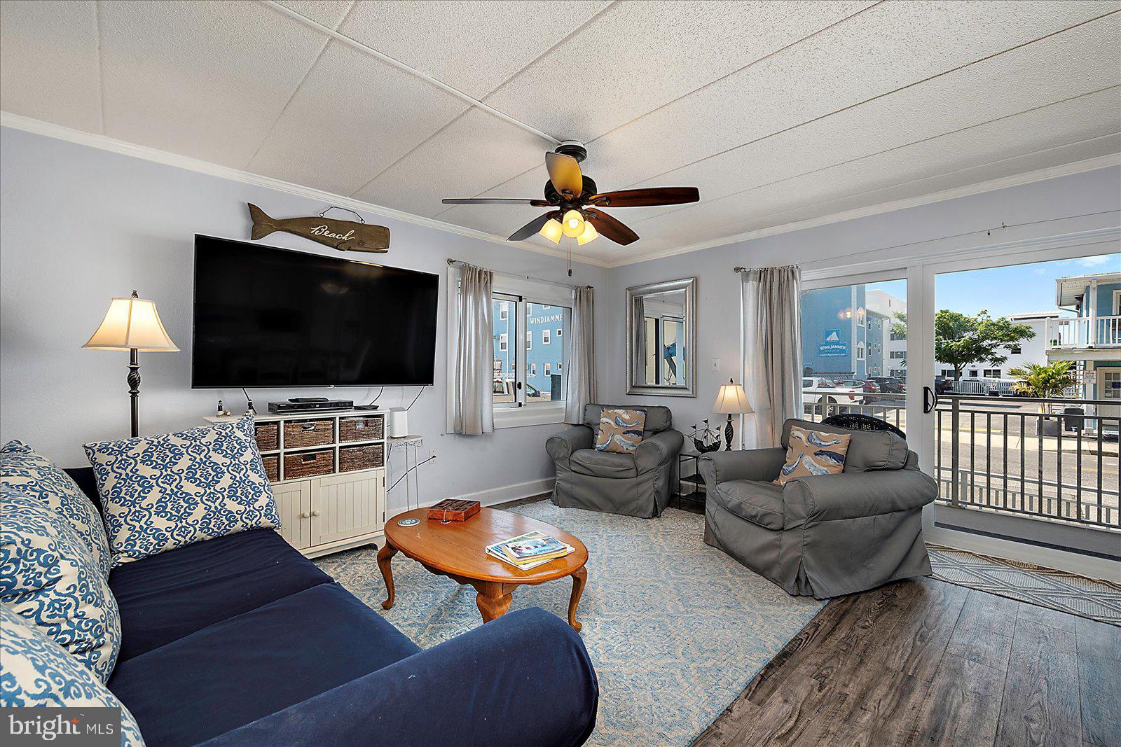 4 46th Street, Unit 101 Ocean City, MD 21842 - Photo 2 of 27 a living room with furniture and a flat screen tv