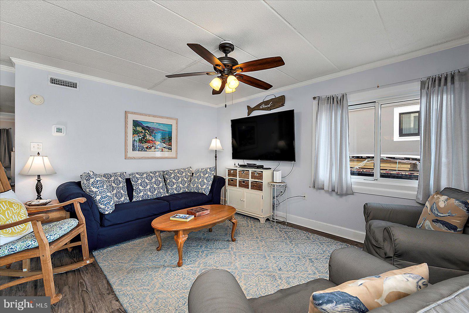 4 46th Street, Unit 101 Ocean City, MD 21842 - Photo 3 of 27 a living room with furniture and a flat screen tv