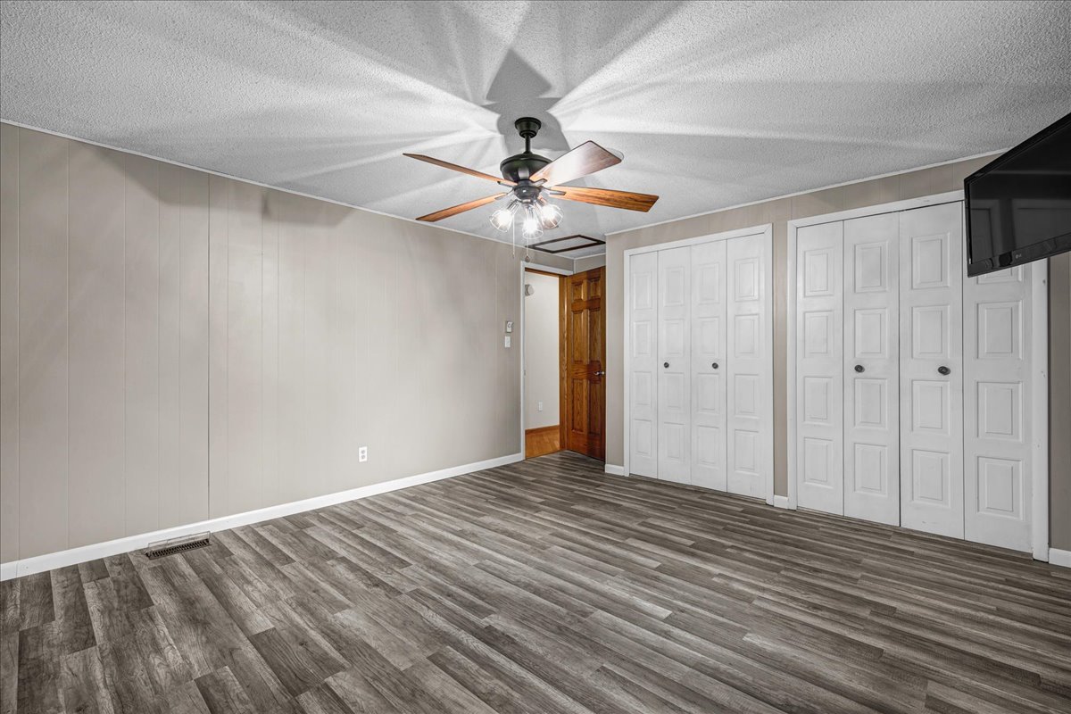 708 North 1950th Road Tonica, IL 61370 - Photo 19 of 95 a view of empty room with wooden floor and fan