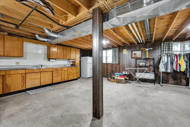 a kitchen with stainless steel appliances wooden floors stove dining table and chairs