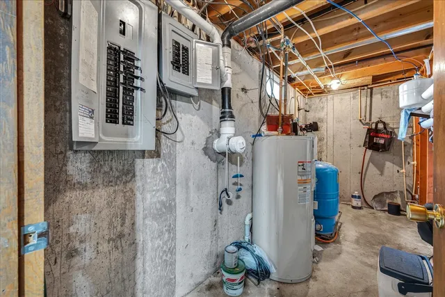 a bed sitting in a bedroom next to a larger window