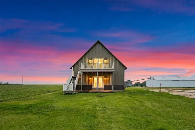 a view of a livingroom with wooden floor and furniture