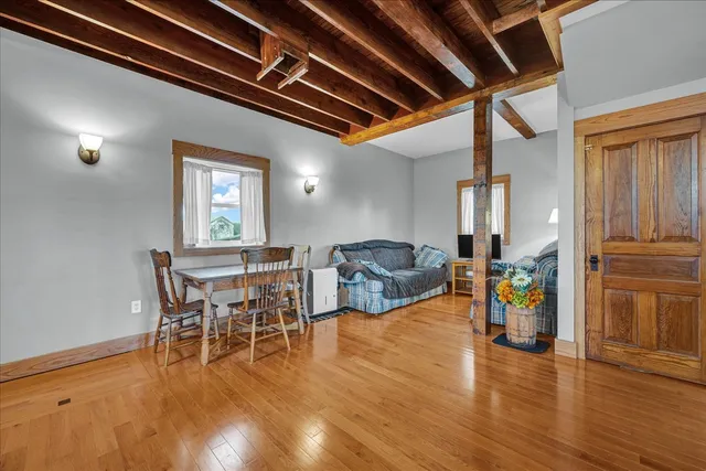a view of a house with a big yard and large trees