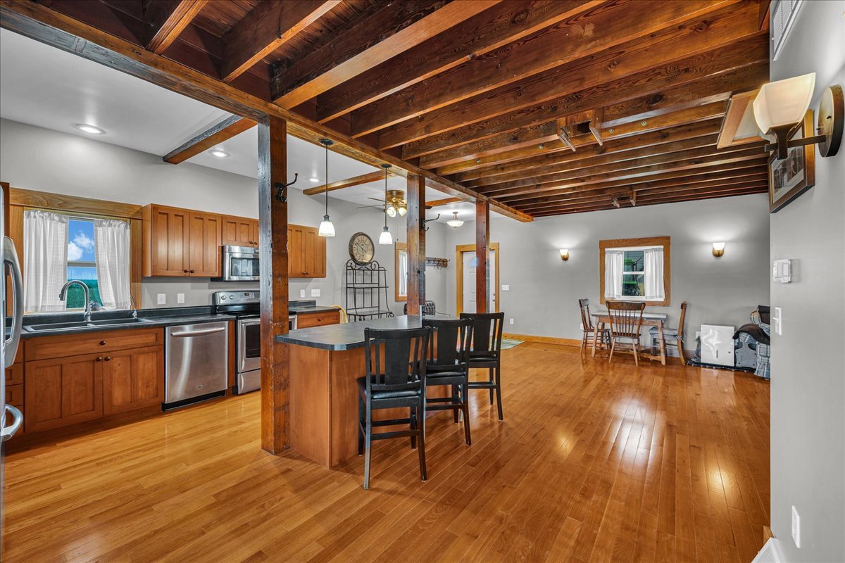 708 North 1950th Road Tonica, IL 61370 - Photo 38 of 95 a kitchen with stainless steel appliances wooden floors stove dining table and chairs