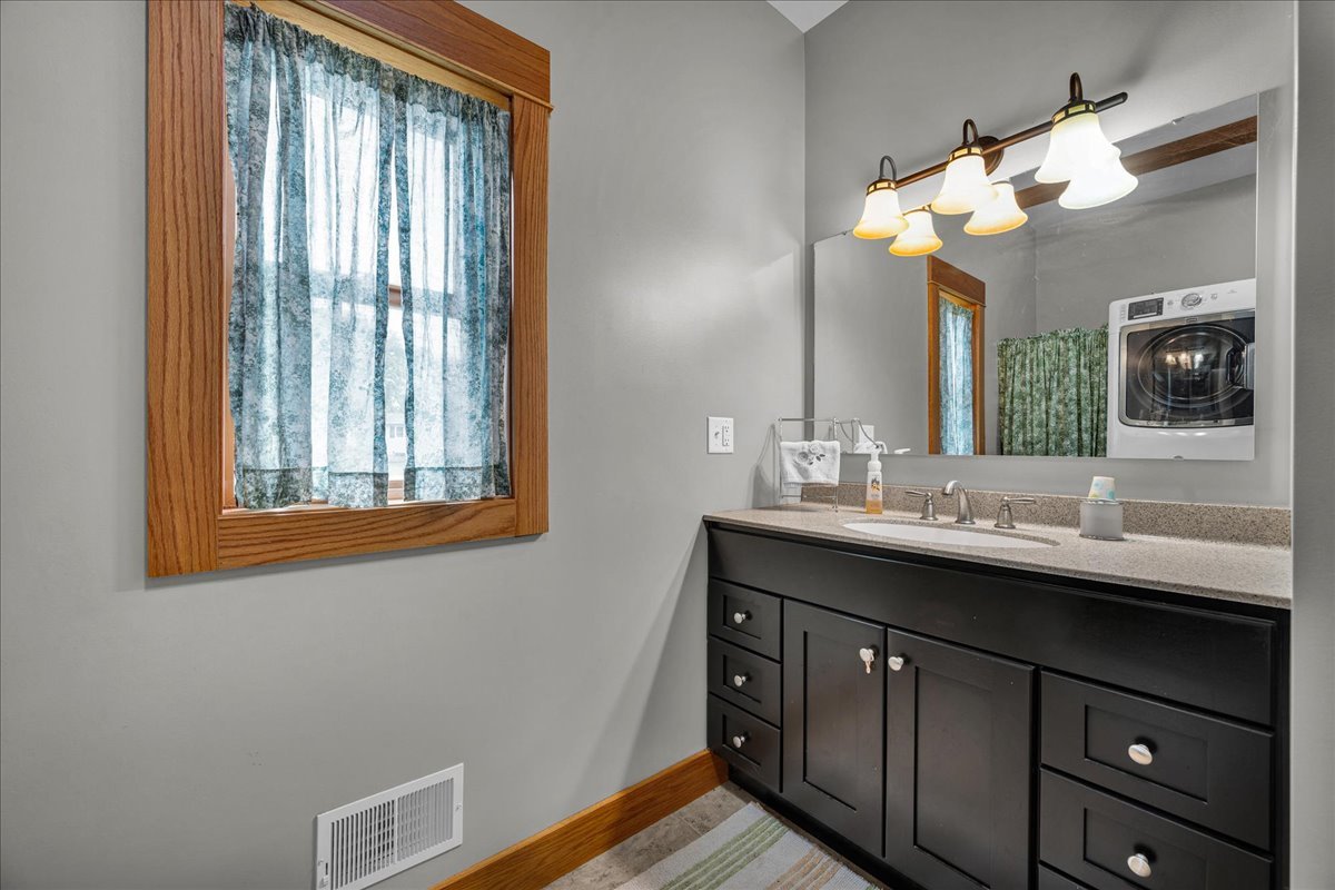 708 North 1950th Road Tonica, IL 61370 - Photo 44 of 95 a bathroom with a double vanity sink and a mirror