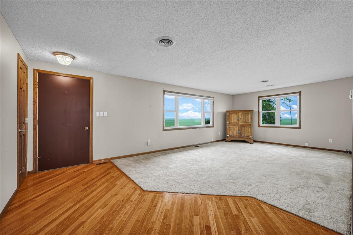708 North 1950th Road Tonica, IL 61370 - Photo 7 of 95 a view of empty room with wooden floor and fan