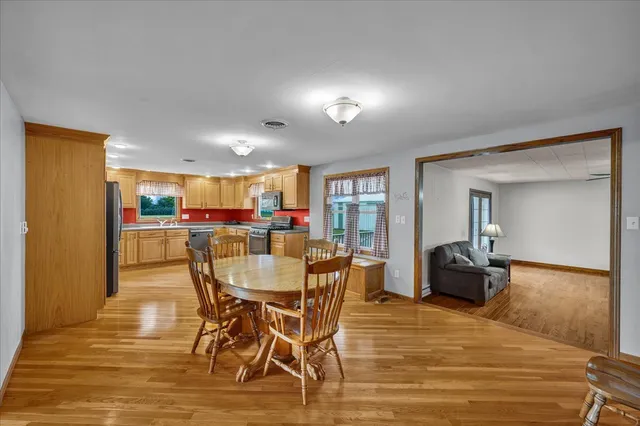 a kitchen with stainless steel appliances granite countertop a stove a sink dishwasher and a refrigerator