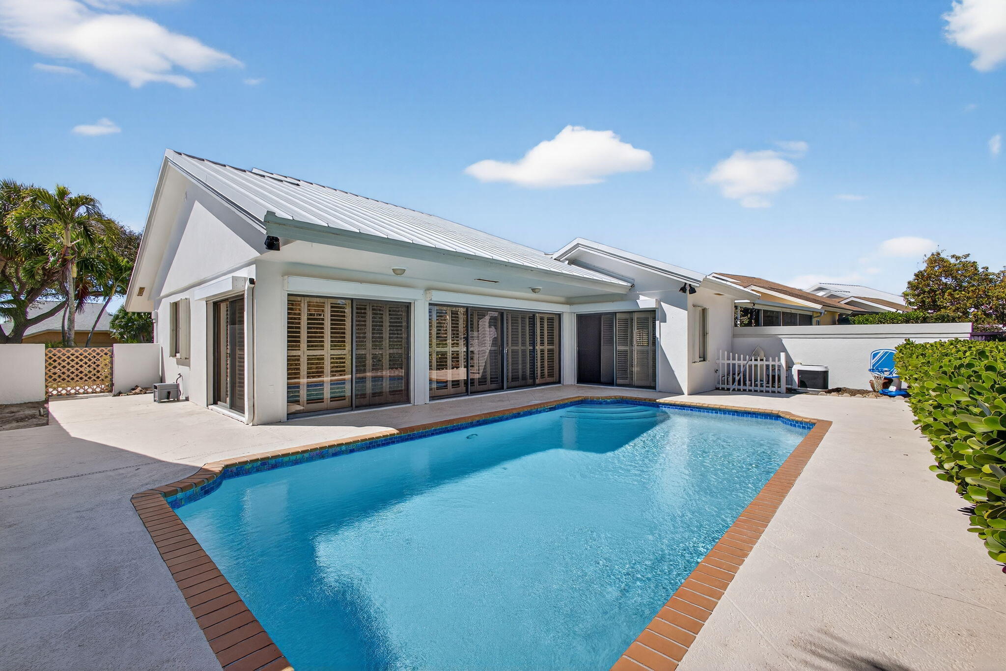 239 Ridge Road Jupiter, FL 33477 - Photo 55 of 75 a view of a house with swimming pool and sitting area