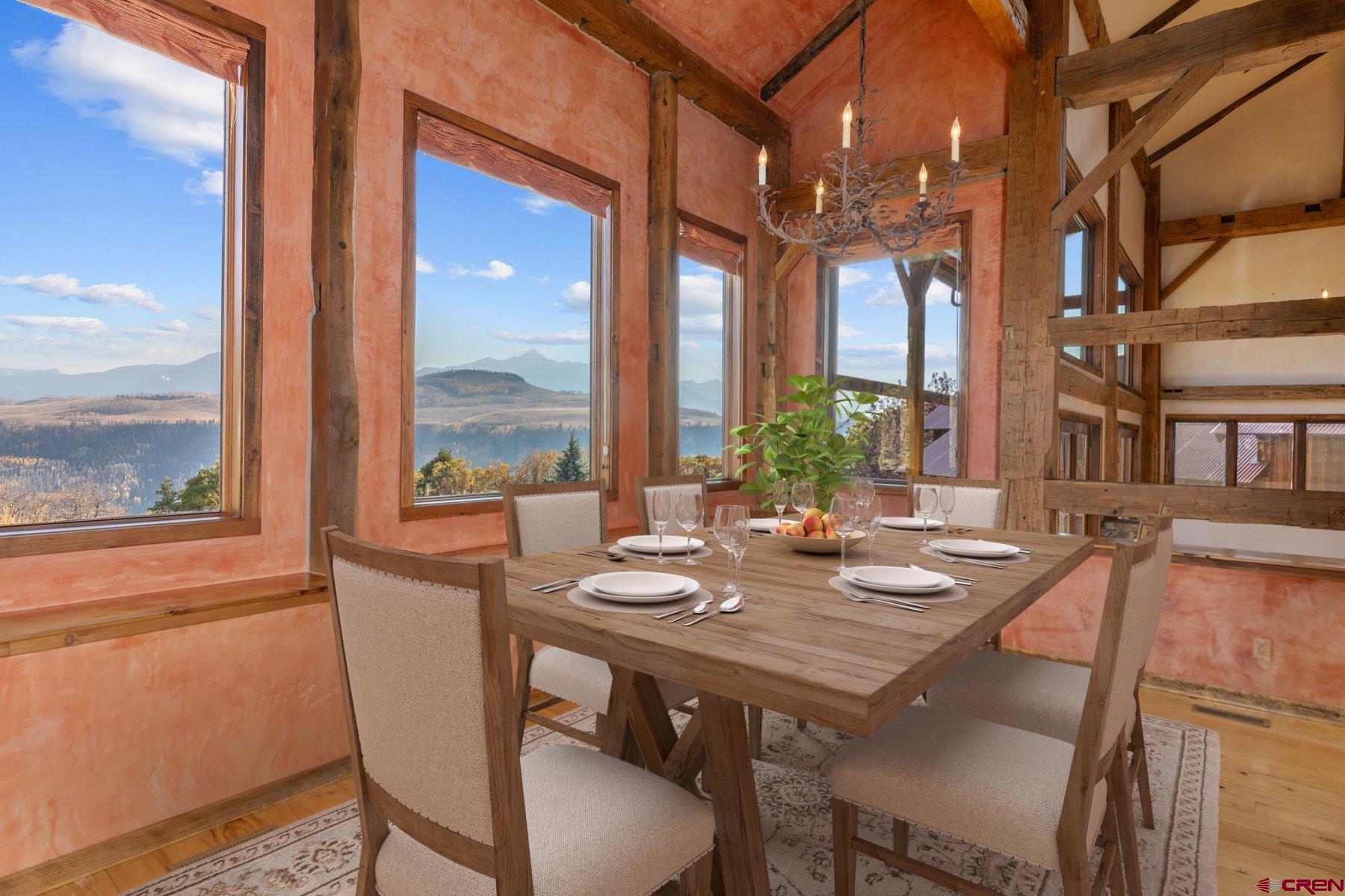685 Wilson Way Telluride, CO 81435 - Photo 11 of 16 a view of a dining room with furniture large windows and wooden floor