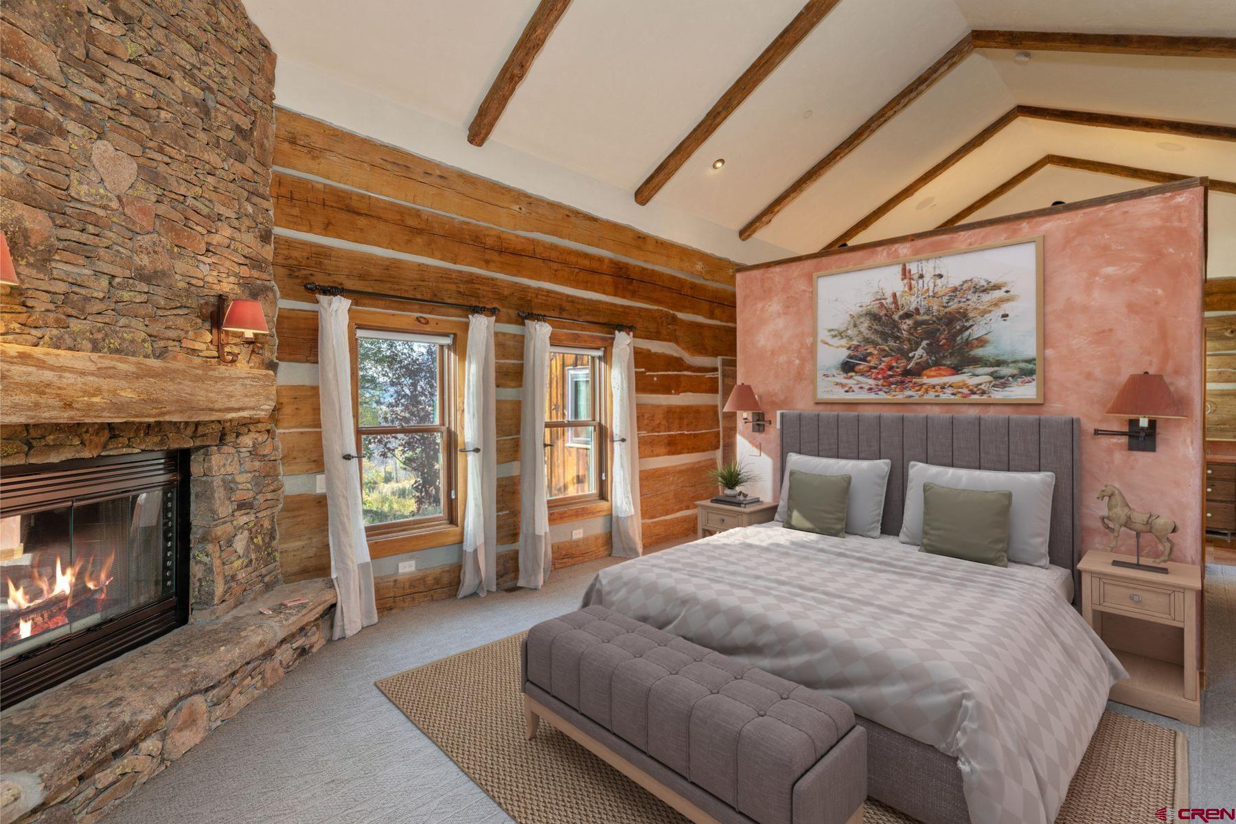 685 Wilson Way Telluride, CO 81435 - Photo 12 of 16 a bedroom with a bed and a fireplace