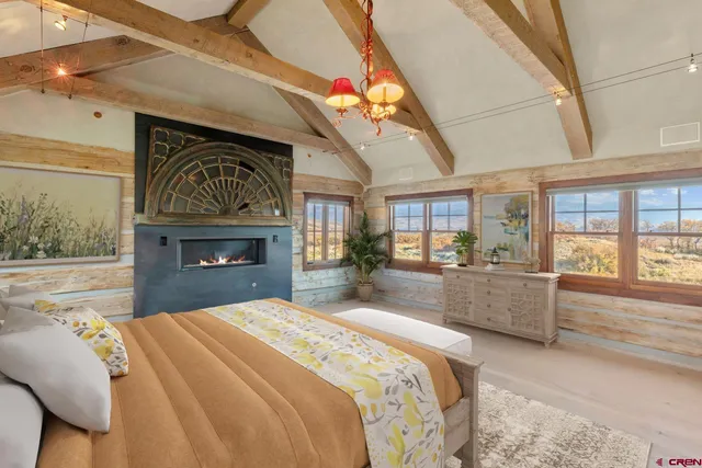 a large hall with wooden floor and chandelier