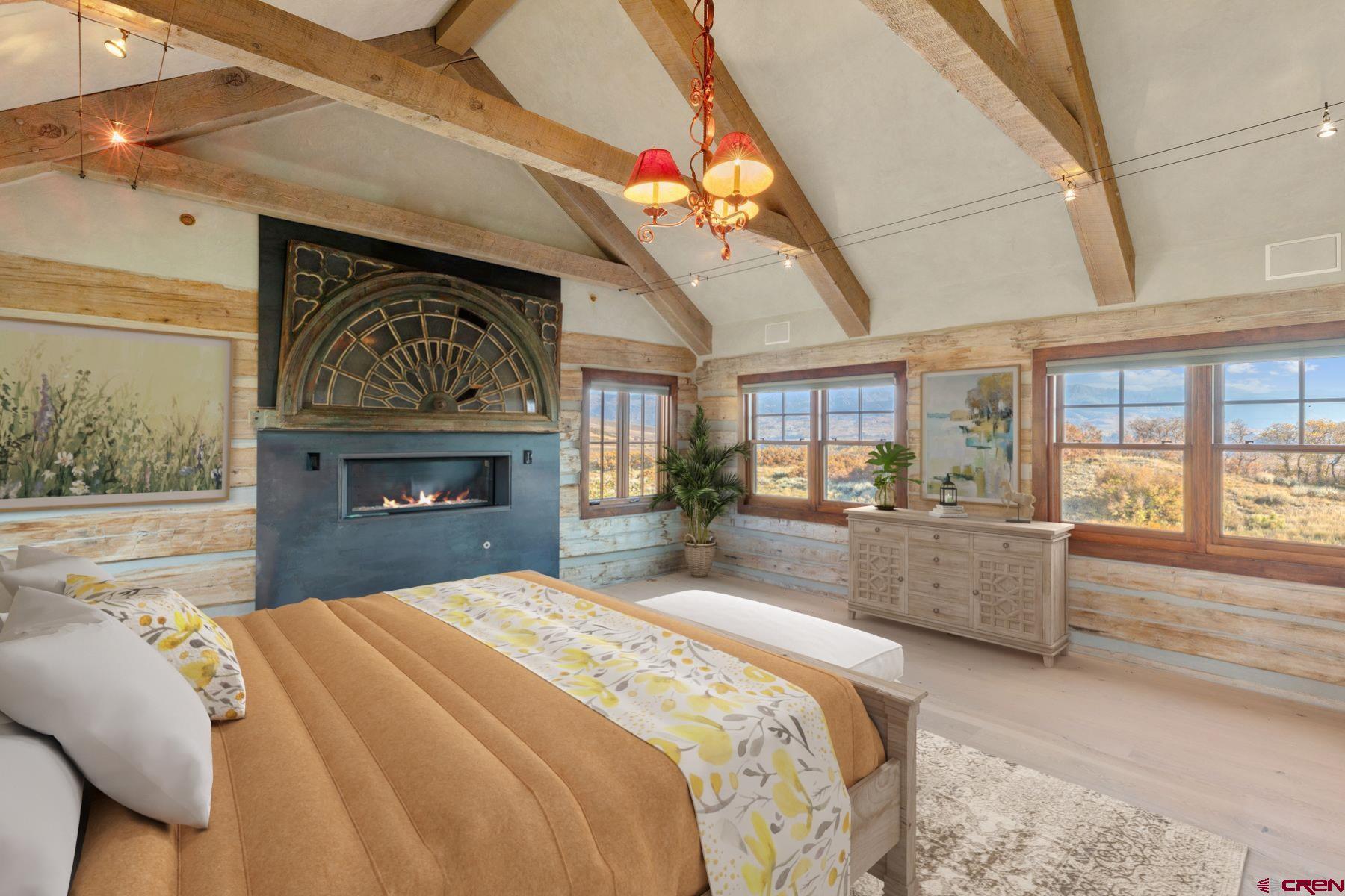 685 Wilson Way Telluride, CO 81435 - Photo 6 of 16 a large bedroom with a bed and a fireplace