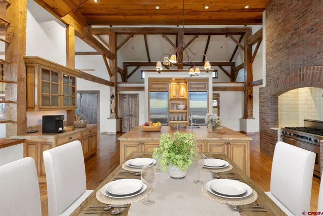 a view of a dining room with furniture large windows and wooden floor