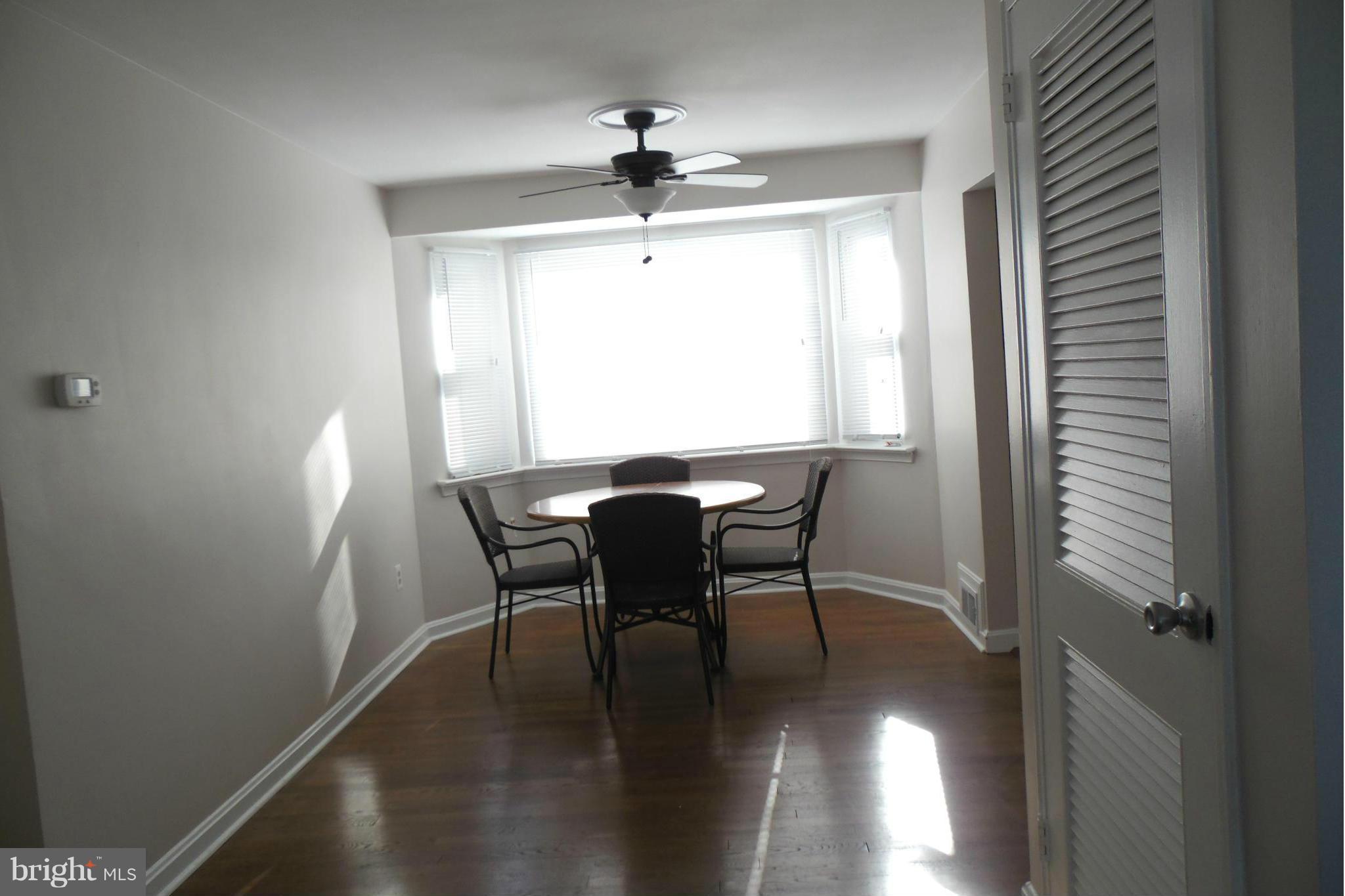 1303 Ray Road Hyattsville, MD 20782 - Photo 5 of 17 a view of a dining room with furniture window and wooden floor