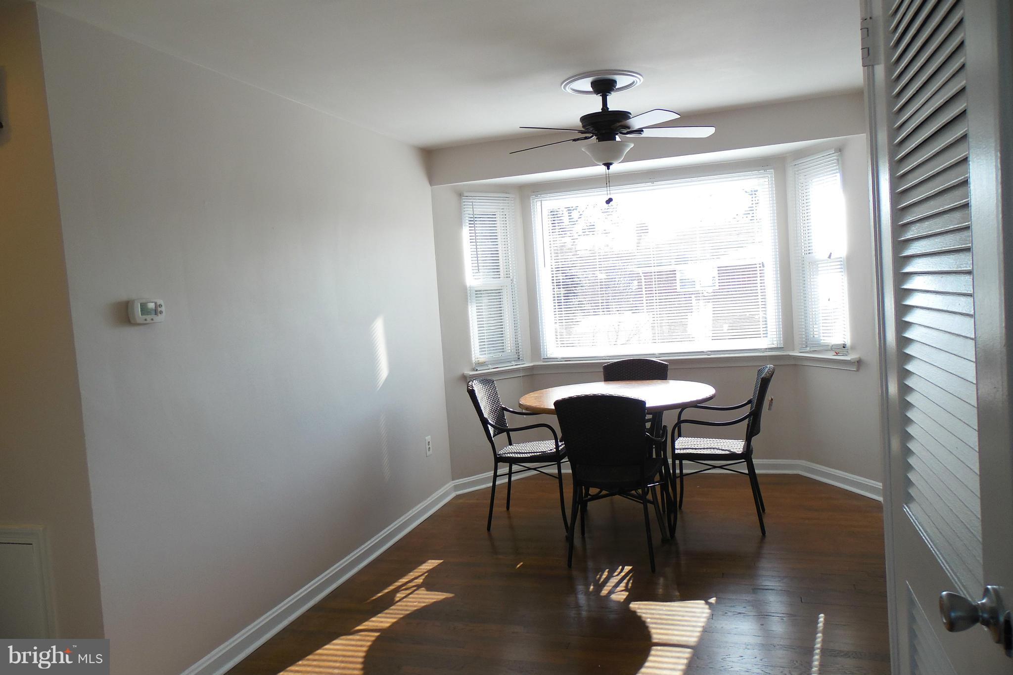 1303 Ray Road Hyattsville, MD 20782 - Photo 6 of 17 a dining room with furniture a chandelier and wooden floor