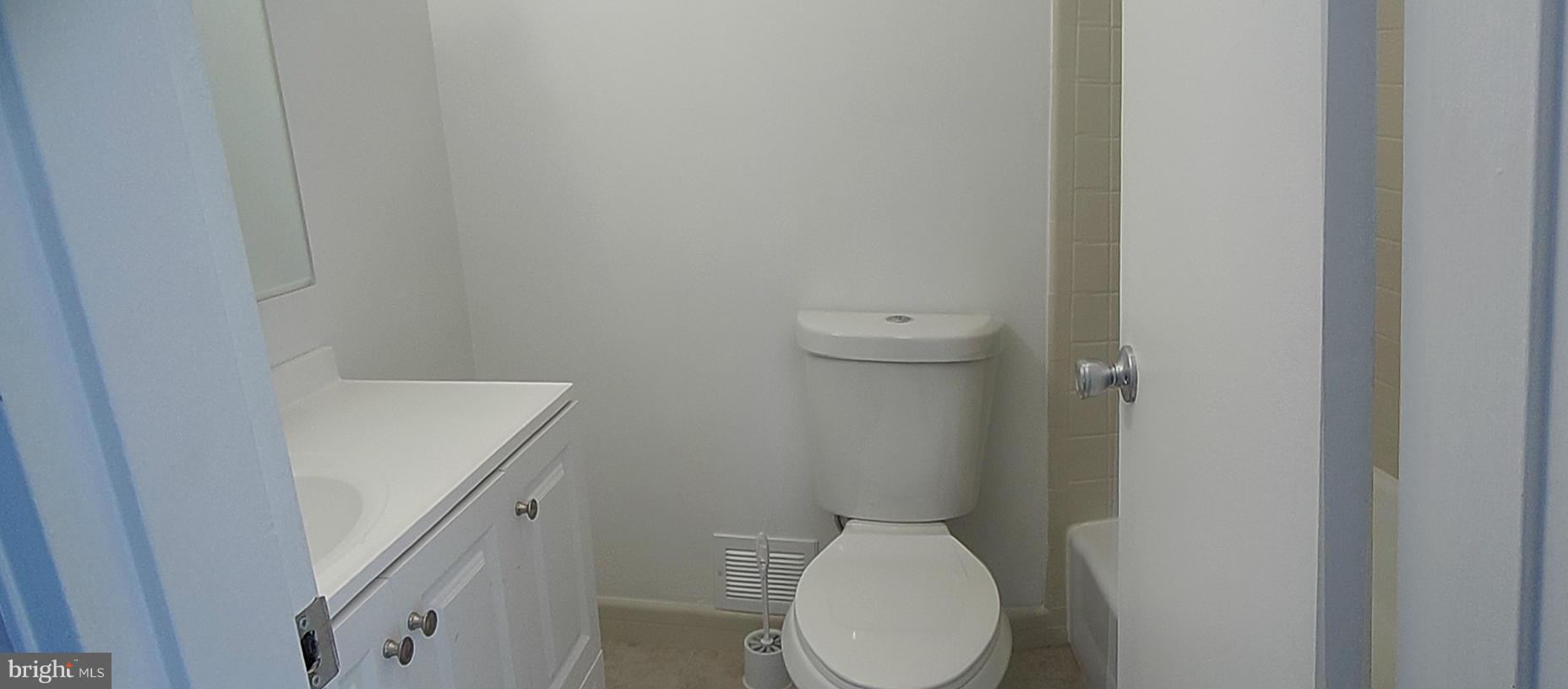 1303 Ray Road Hyattsville, MD 20782 - Photo 9 of 17 a white toilet sitting next to a white sink