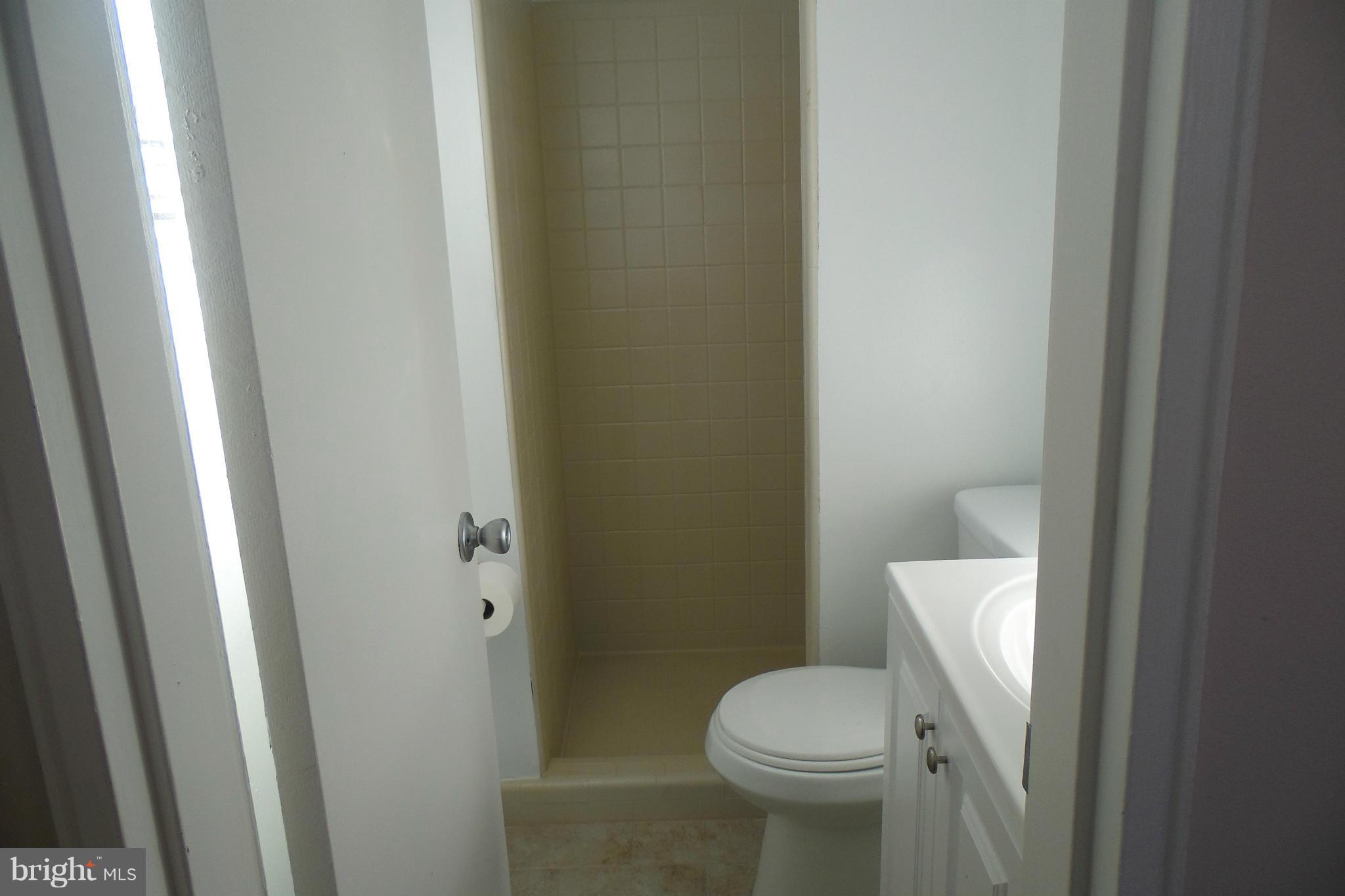 1303 Ray Road Hyattsville, MD 20782 - Photo 10 of 17 a white toilet sitting next to a white cabinet