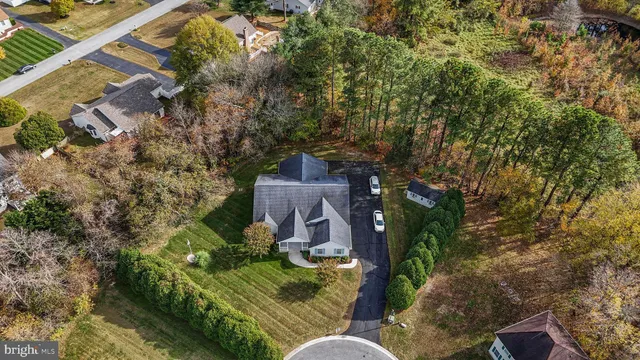 an aerial view of a house with garden space and street view