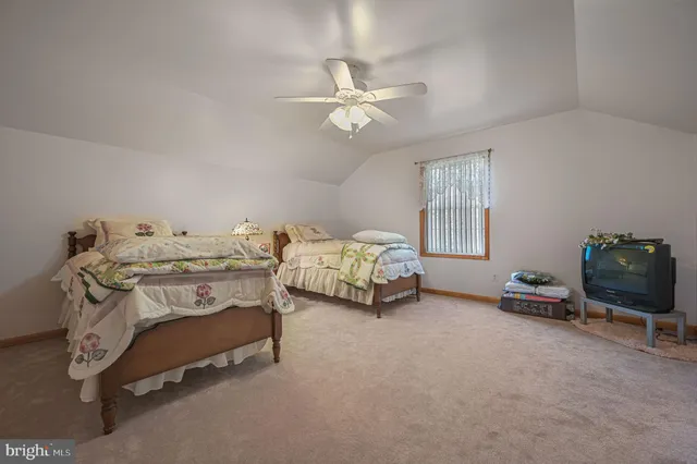 a bedroom with bed and a chandelier