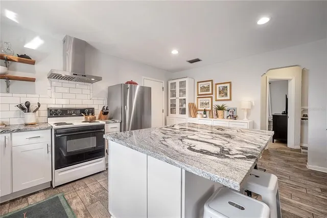 a kitchen with a sink stainless steel appliances and cabinets