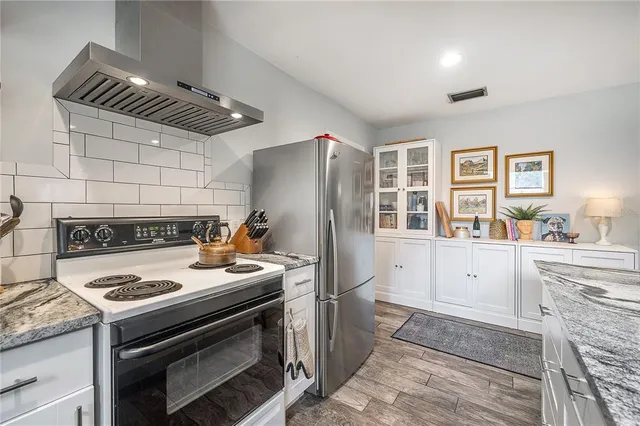 a view of a bedroom with a window and wooden floor