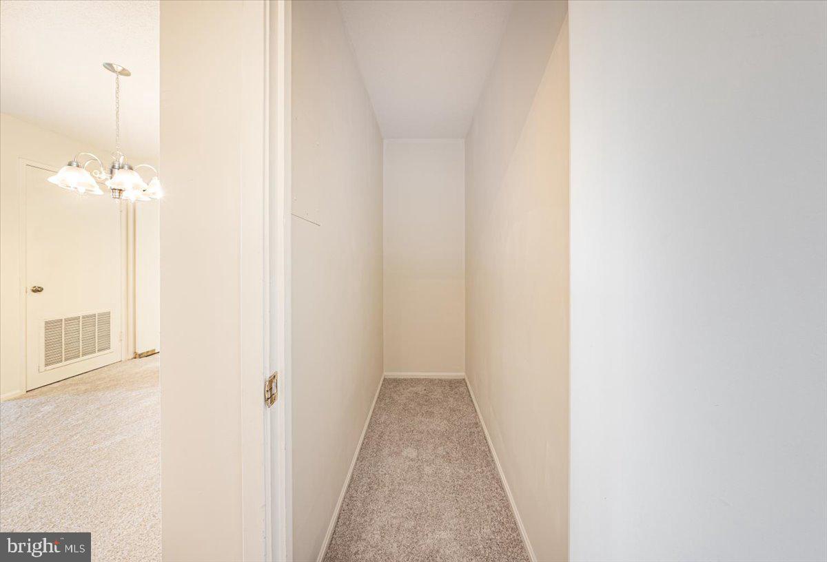 15101 Interlachen Drive, Unit 1807 Silver Spring, MD 20906 - Photo 12 of 50 a view of a hallway with white walls