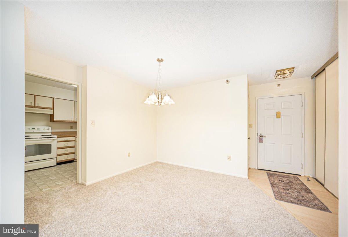 15101 Interlachen Drive, Unit 1807 Silver Spring, MD 20906 - Photo 14 of 50 an empty room with cabinet and mirrors