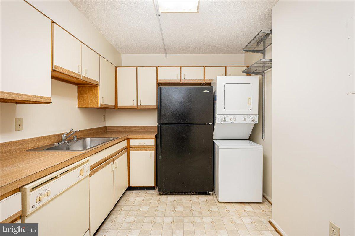 15101 Interlachen Drive, Unit 1807 Silver Spring, MD 20906 - Photo 24 of 50 a kitchen with a refrigerator and a sink