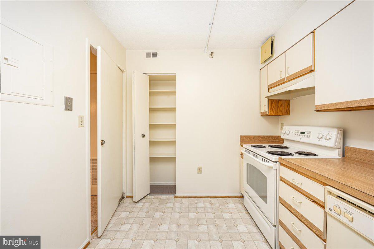 15101 Interlachen Drive, Unit 1807 Silver Spring, MD 20906 - Photo 25 of 50 a kitchen with a stove cabinets and a refrigerator