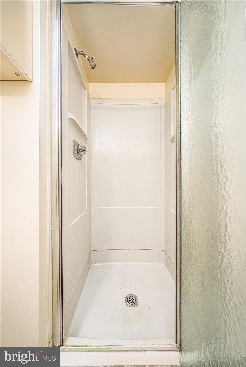 15101 Interlachen Drive, Unit 1807 Silver Spring, MD 20906 - Photo 31 of 50 a bathroom with a glass shower door