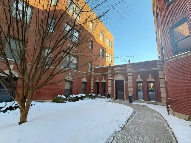 a view of a building with a snow on the road